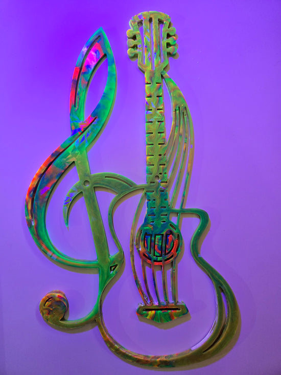 Decorative florescent wall art featuring a note joined with a guitar
