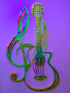 Decorative florescent wall art featuring a note joined with a guitar